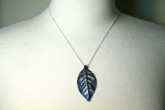 Iron leaf pendant hung from sterling silver chain