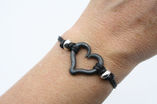 Iron heart bracelet with sliding clasp and black cord sides. One size fits all