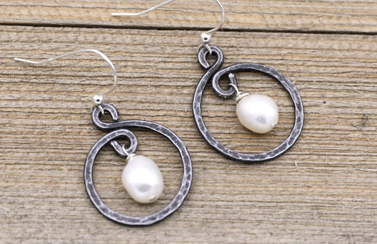 iron hoop earrings with white pearl in the center