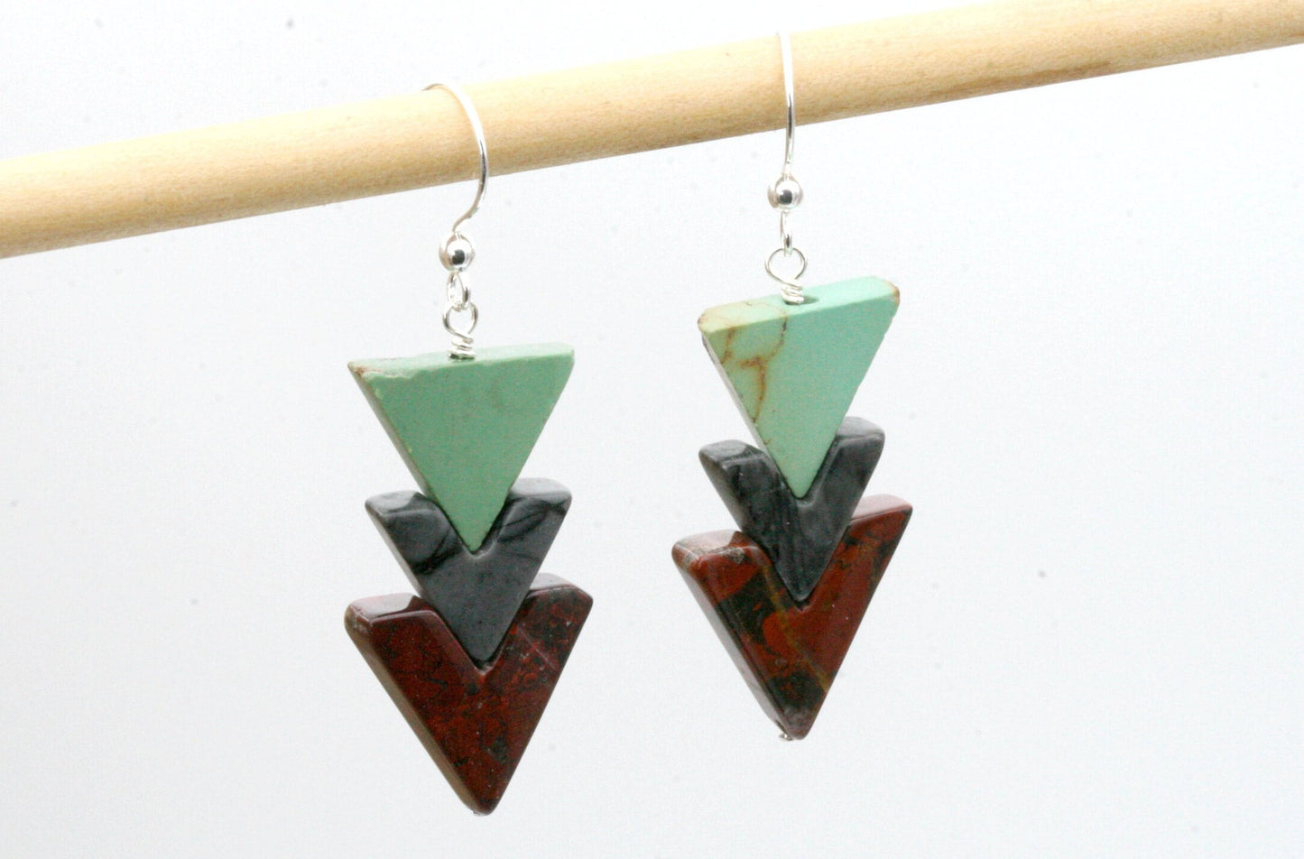 The long awaited and ever popular stone triangle earrings- These are made using incredibly rare vintage stone beads in a chevron cut. I have a limited amount of these beads so once they are gone thats it!

Robins egg blue genuine turquoise, grey jasper and red wine jasper triangles (incredibly earthy red) create these stunning earrings.