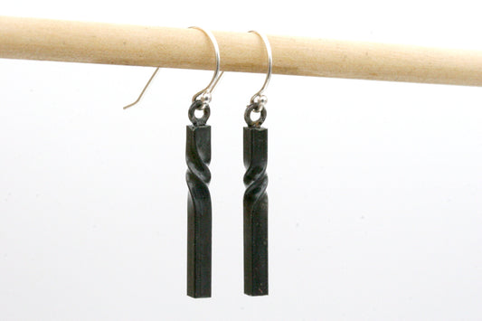 iron twist earrings hung from sterling silver ear wires. Black color with simple modern vertical bars with elegant twists